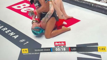 Liza oddaje puchar po wygranej z Nanami Chan na Fame Friday Arena 1